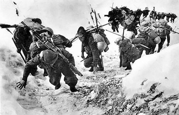 An Alpini unit struggles up a snow-covered mountainside. 