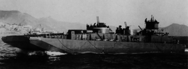 An up-armoured F-Lighter, somewhere in the Mediterranean. You can see the twin-barreled 20mm cannons amidships, with the shadow of a larger calibre gun towards the stern. 